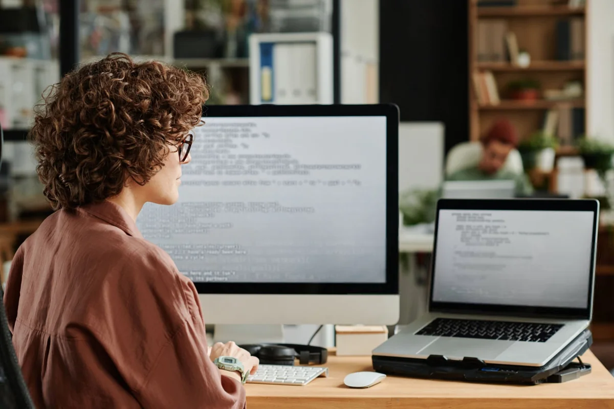 Legal support professional working at a desk with two monitors