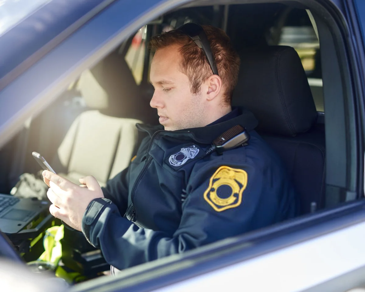 Police officer in a parked patrol car
