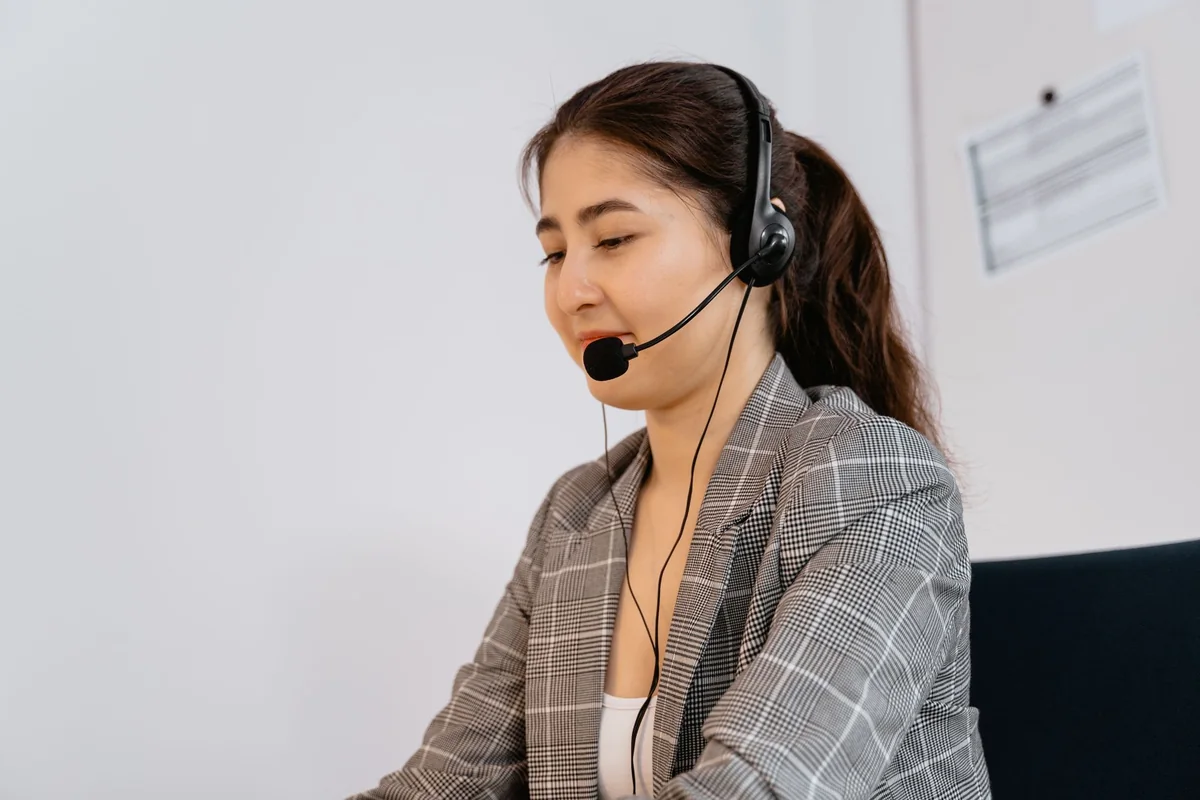 Manager dictating at her desk with a headset microphone