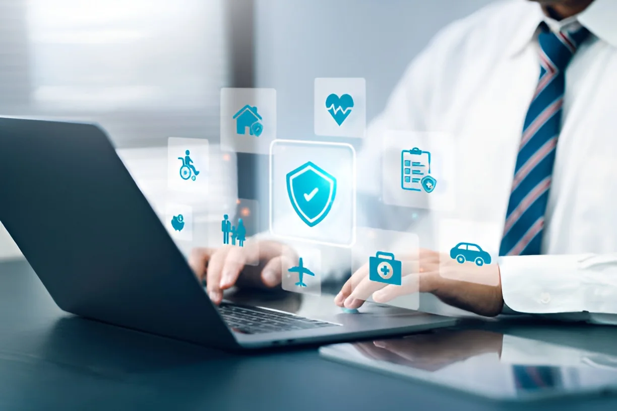 Healthcare professional on a laptop with a security shield and medical icons