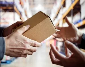 workers with package in a warehouse