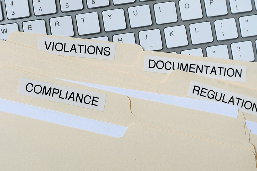 file folders with words compliance violations